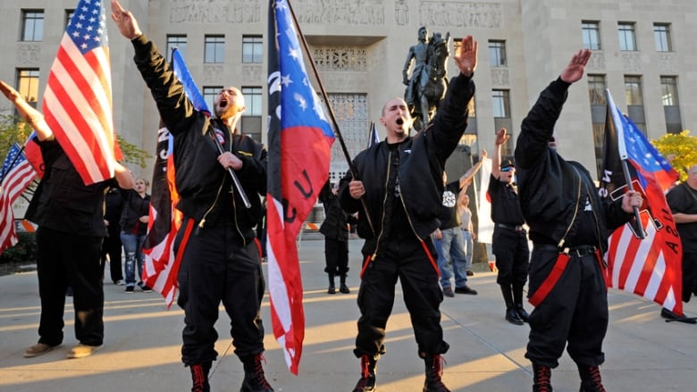 Members of the National Socialist Movement "salute" a speaker during a neo-Nazi rally.