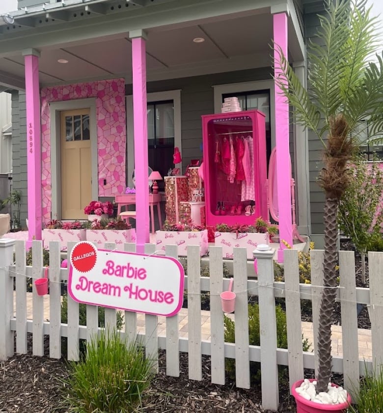 Pink pillars and pink Barbie props with a sign that reads Barbie Dream House